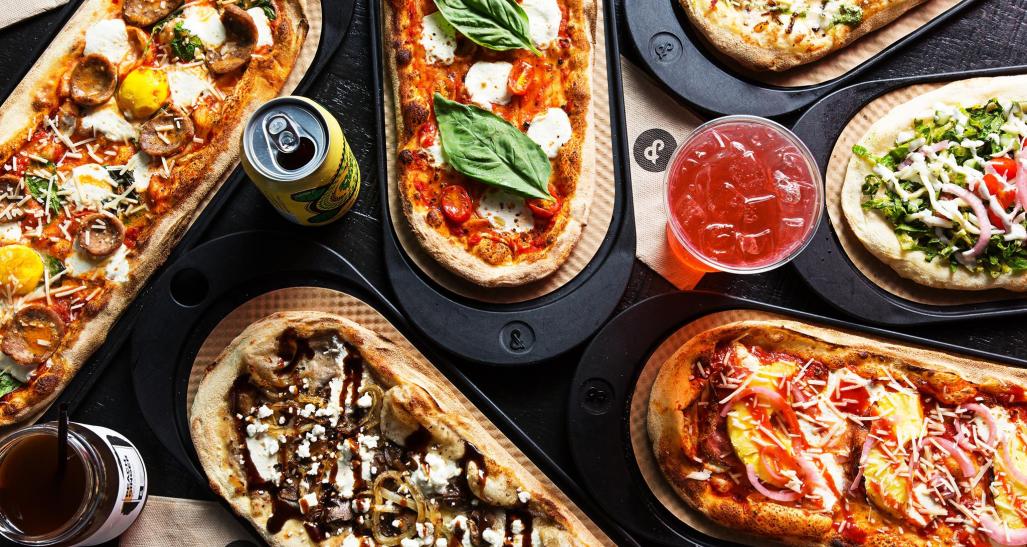 flatlay of pizza and drinks from &pizza