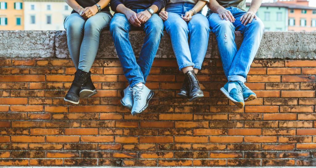 Jeans People sitting on brick wall