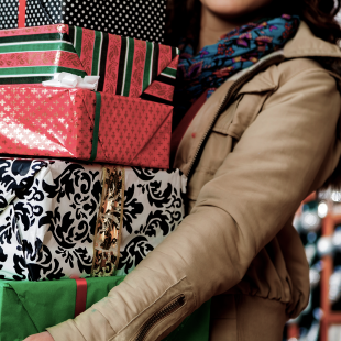 holiday shopper carrying giftwrapped items
