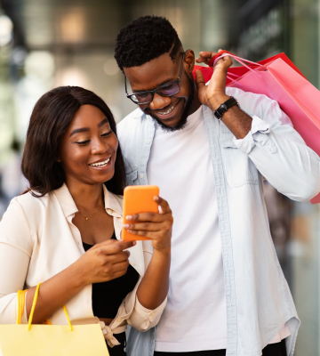 Individuals using a phone to shop.