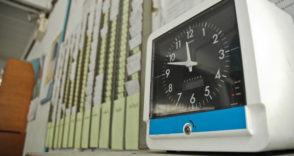 workers punch cards and time clock