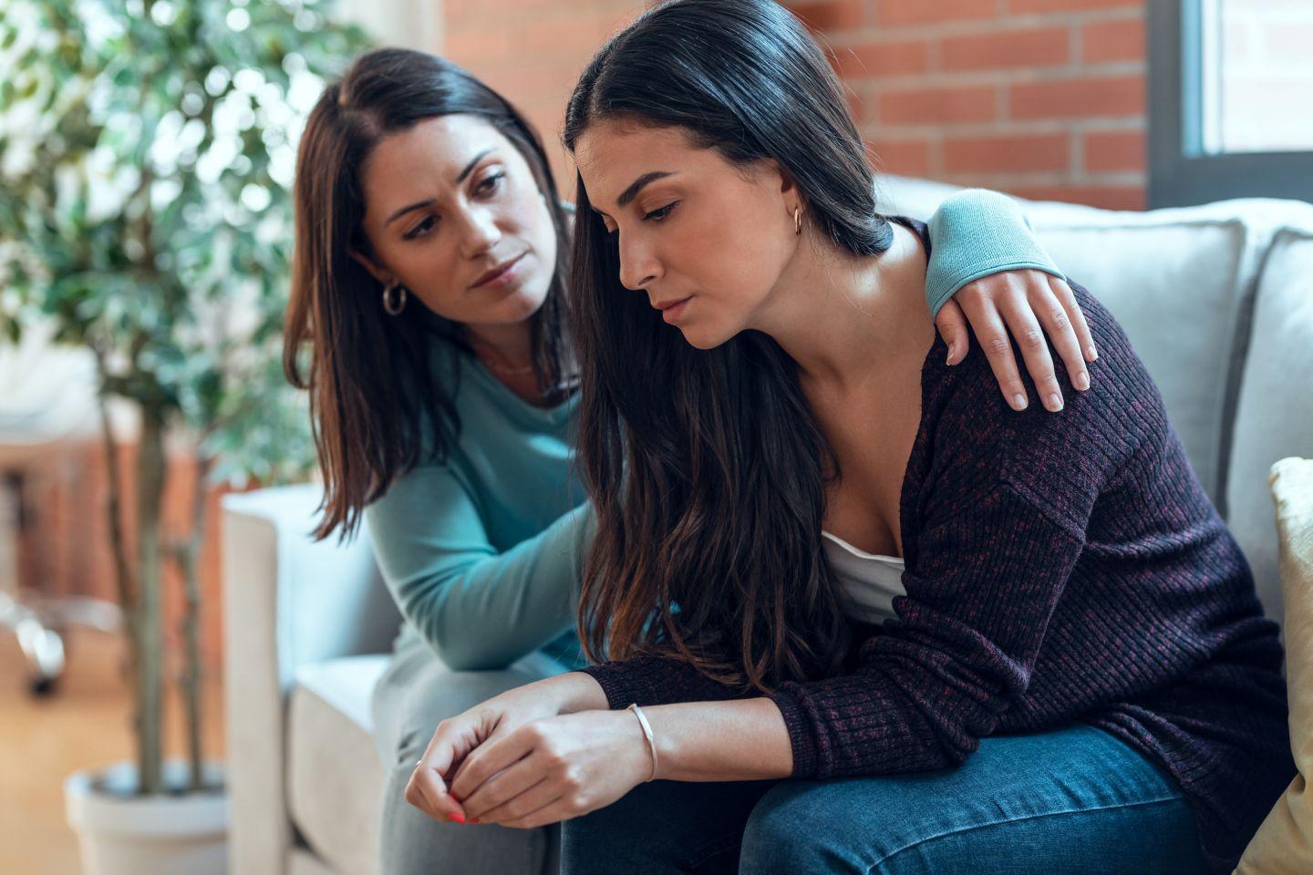 A woman comforting her friend.