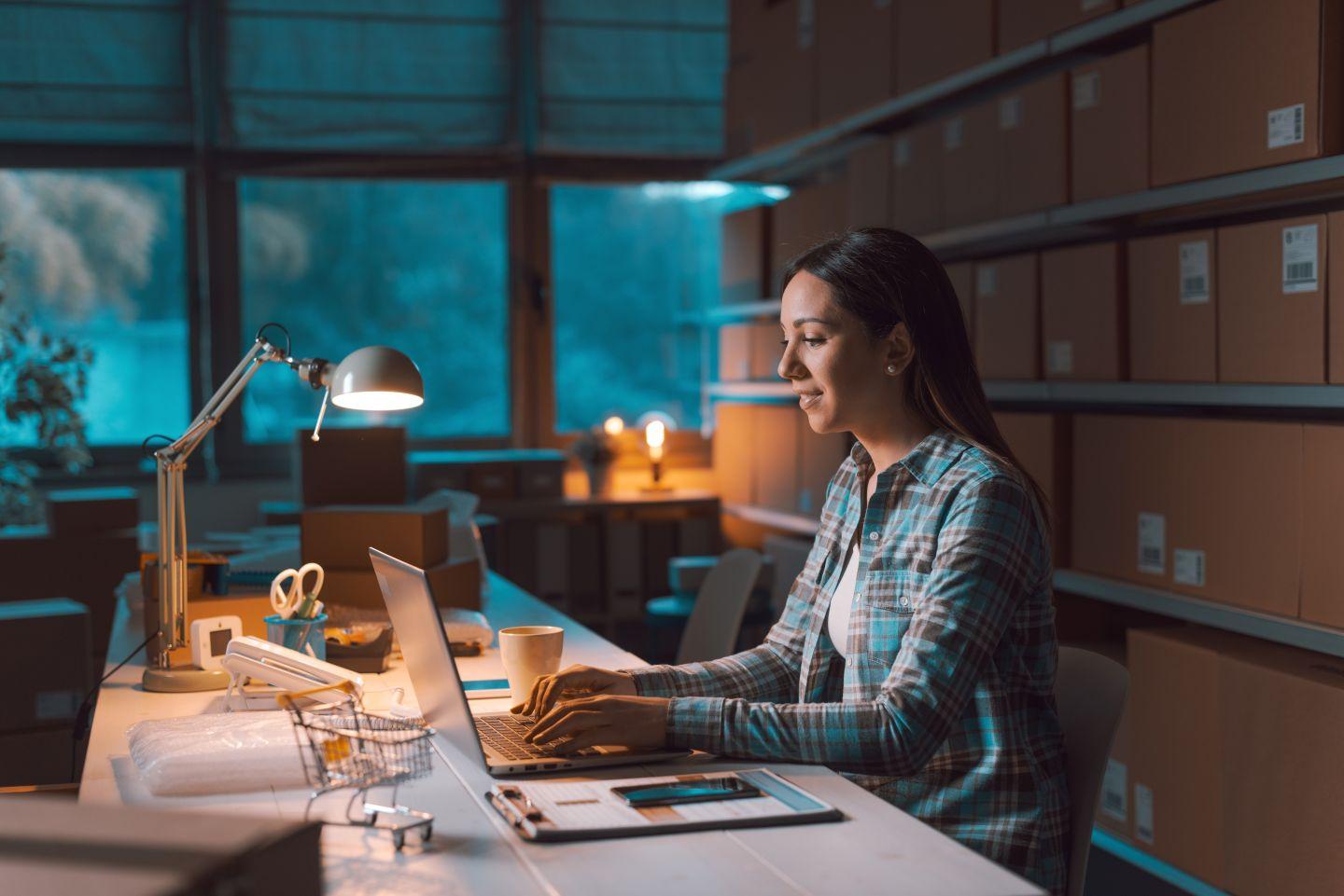 Woman working on laptop.