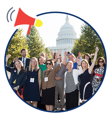 Individuals standing and waving in front of capitol building.