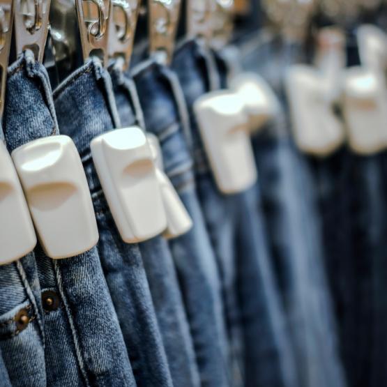 jeans with security tags attached to them.