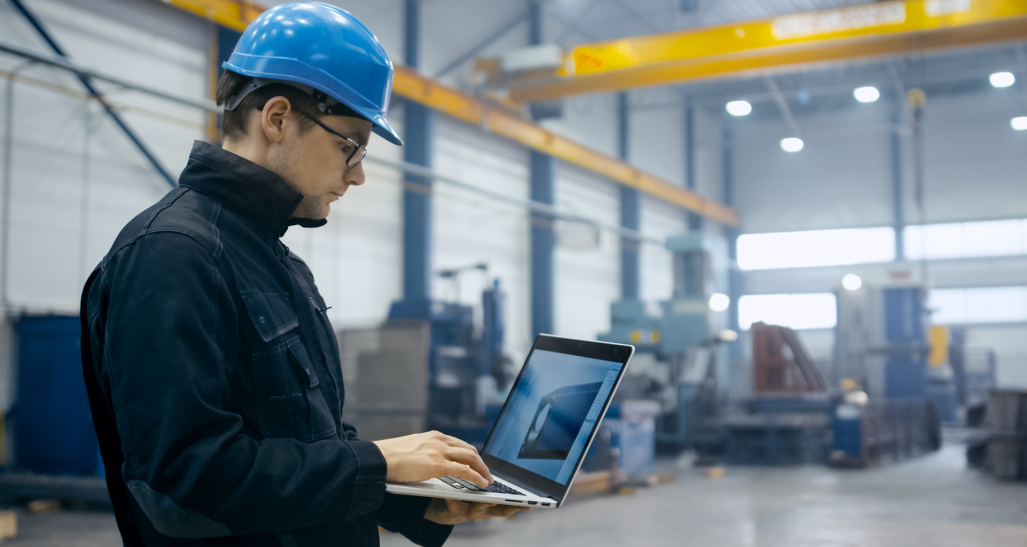 manufacturer worker checking engineering file on a laptop