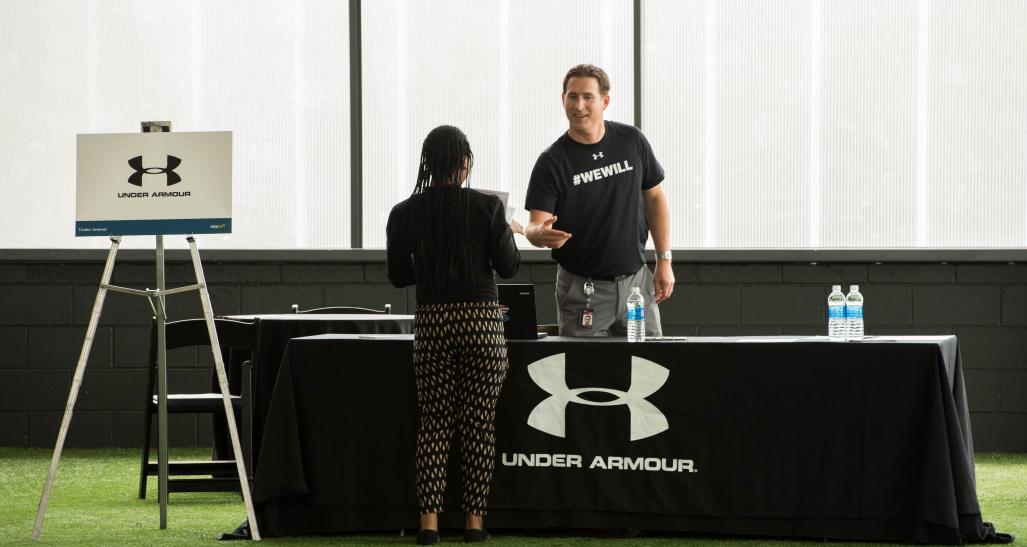Under Armour recruiter speaks to rise up candidate at the Rise Up career fair