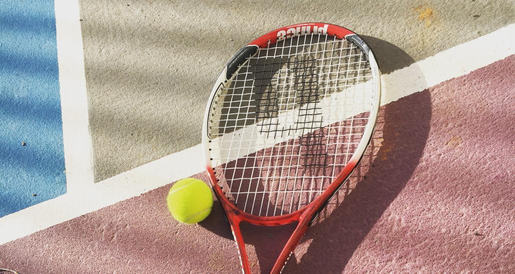tennis racket and a tennis ball on a tennis court
