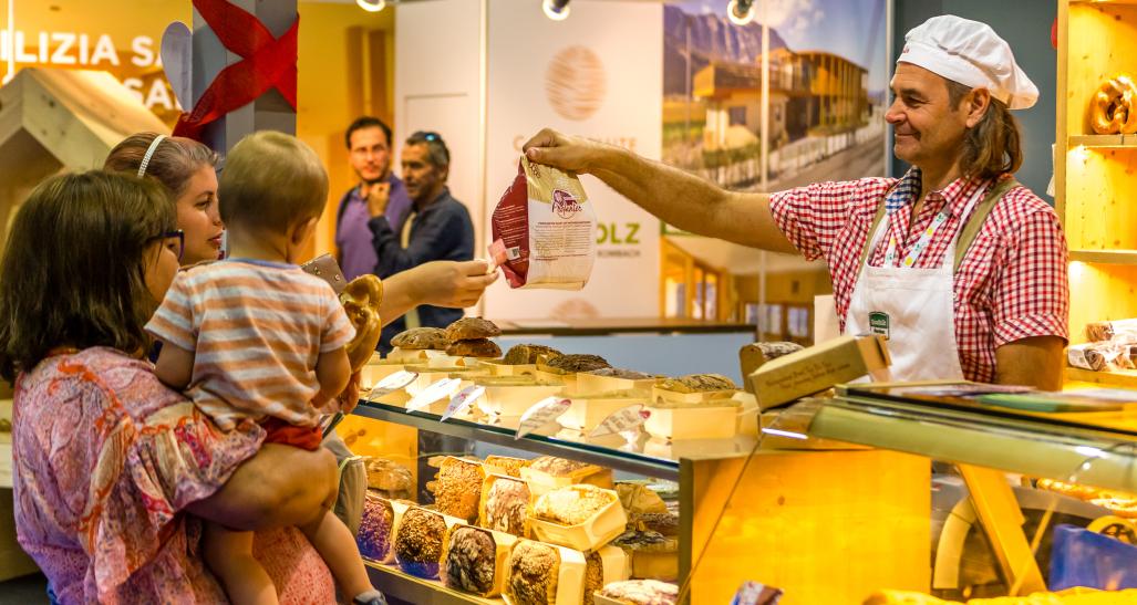 Customers buying bread at small business bakery in Europe