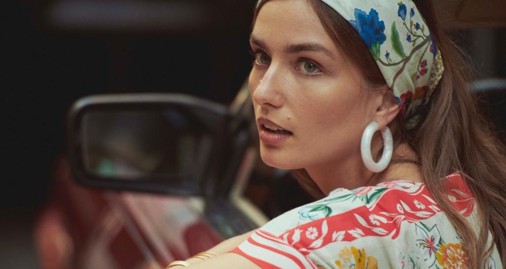 Anthropologie model wearing bandana and colorful shirt