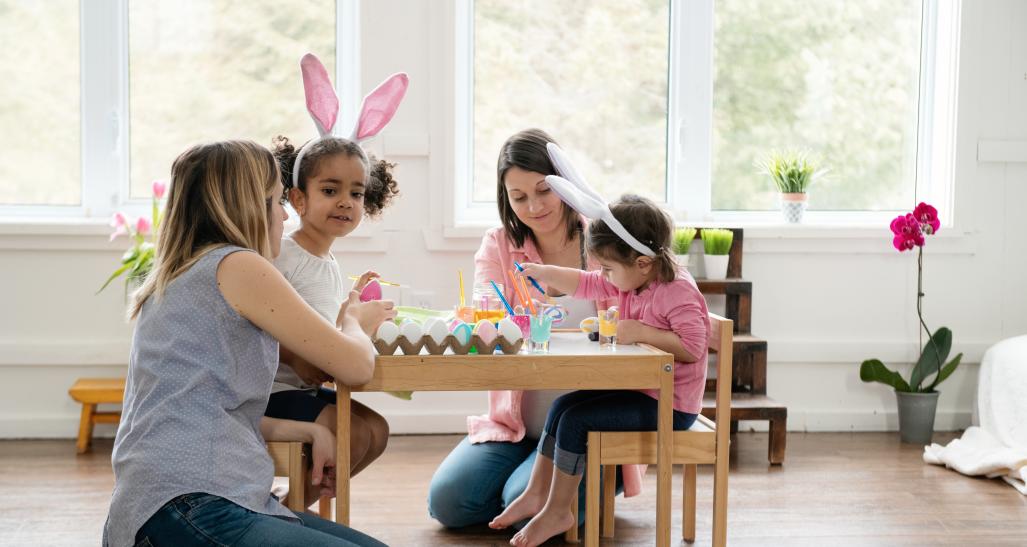 a family is shown with friends painting easter eggs