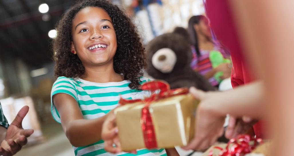 Child donates gift at gift drive