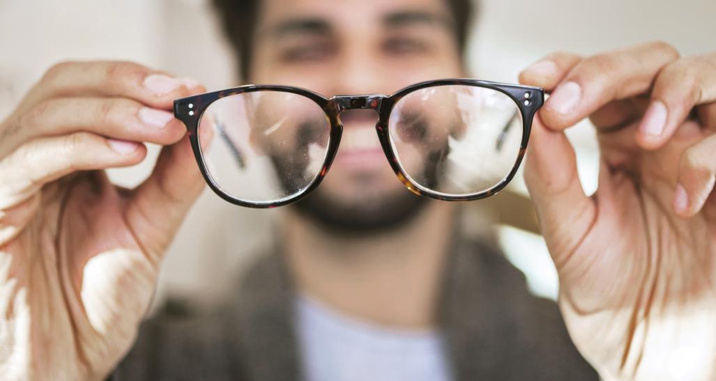 Man looking at eyeglasses