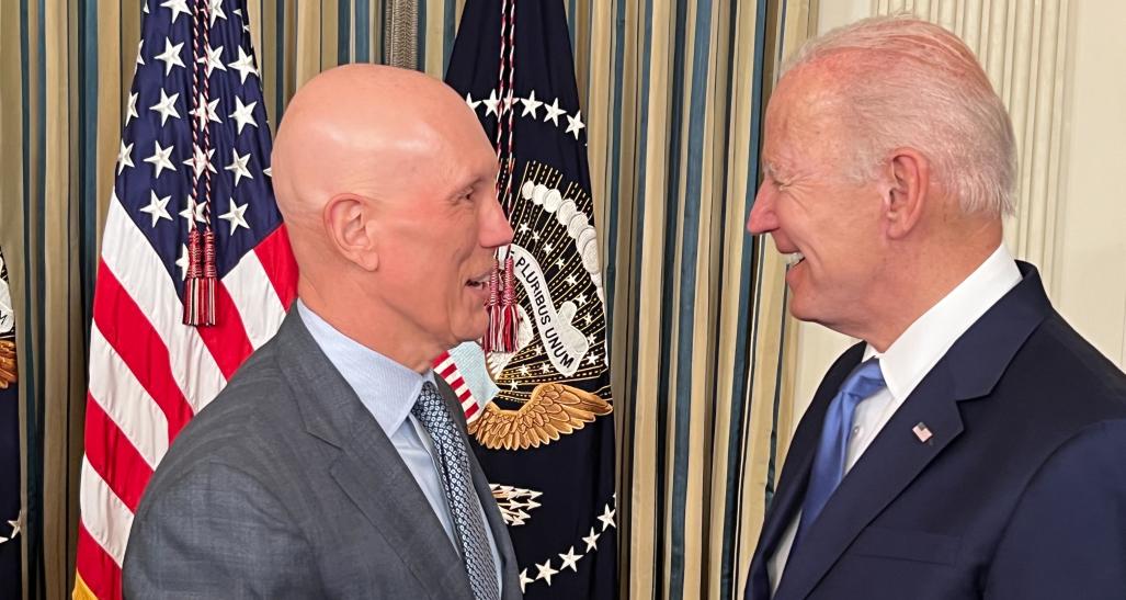 Matt Shay shakes hands with President Joe Biden at a White House bill signin