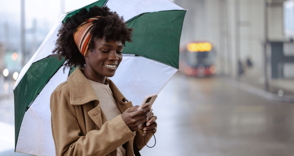 Woman on her phone in the rain. 