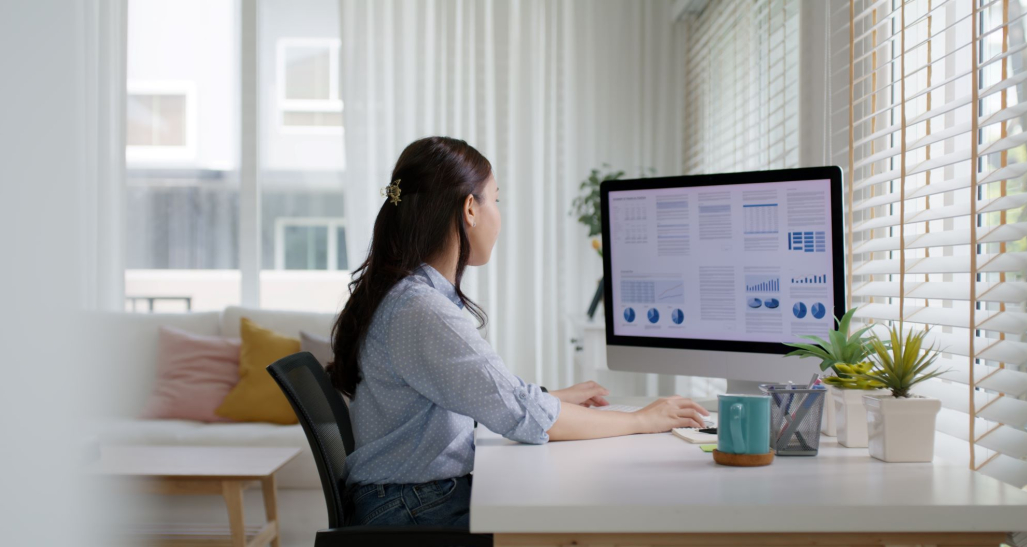 Woman working at a desktop computer.