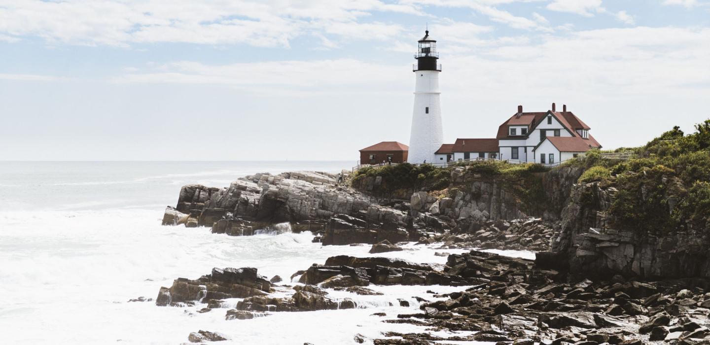 A lighthouse along the rocky coastline of Maine.