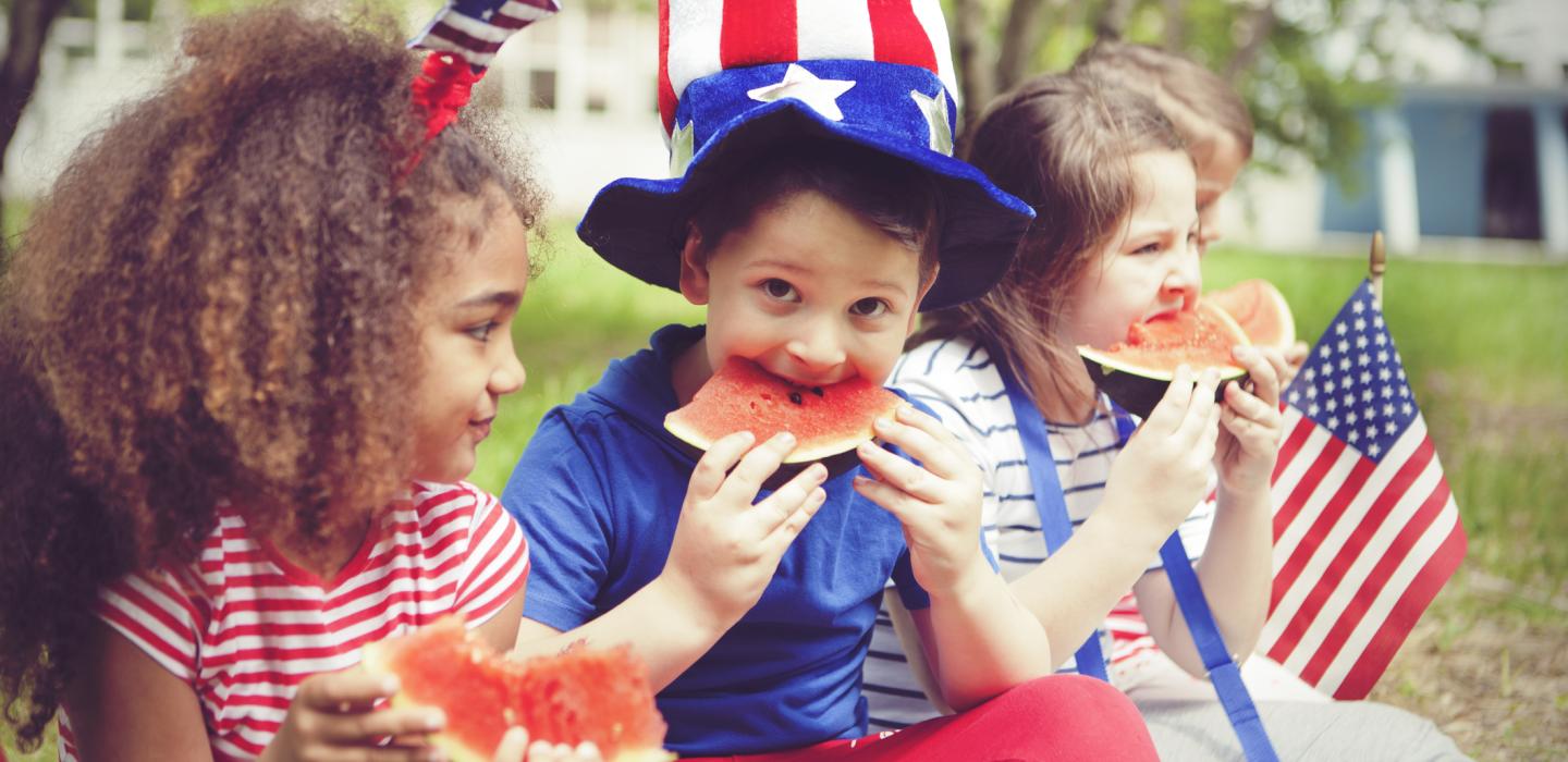 Kids eat watermelon at Fourth of July party