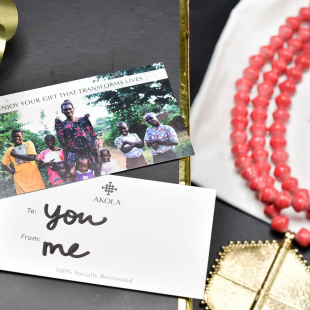 A flatlay of jewelry and a thank you card from Akola, a small jewelry business