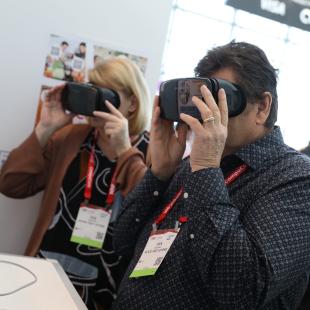 a woman and man look through virtual reality devices in the innovation lab at the big show