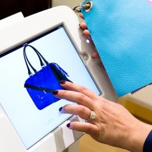 A person is seen customizing a purse through the Mon purse selections