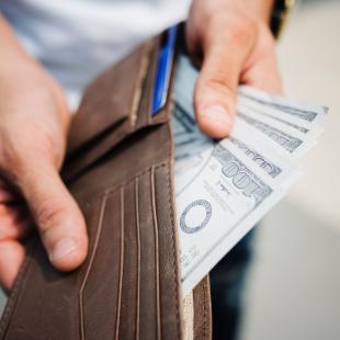 wallet showing hundred dollar bills