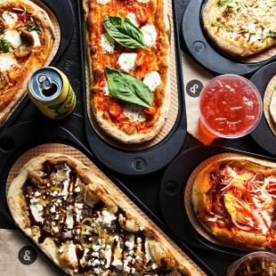 flatlay of pizza and drinks from &pizza