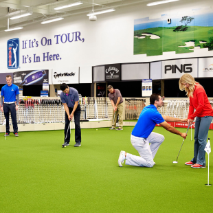 Golfers getting instruction at a PGA Tour Superstore