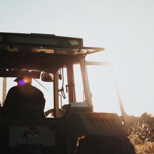 farm worker driving heavy equipment