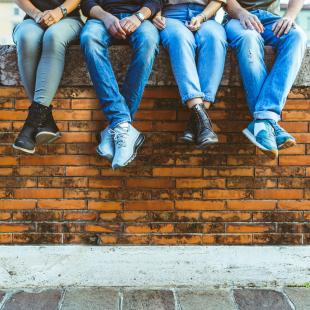 Jeans People sitting on brick wall