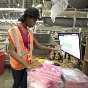 Employee at Williams Sonoma warehouse working on computer