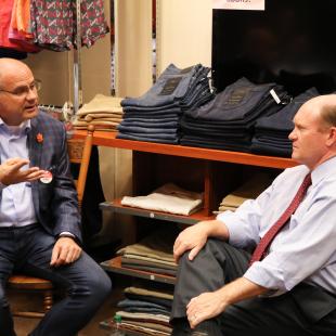 Store owner Trey Kraus speaking with Sen. Coons of Delaware during NRF Store Tour