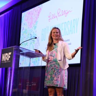 Lilly Pulitzer CEO Michelle Kelly speaking on stage at NRF NXT