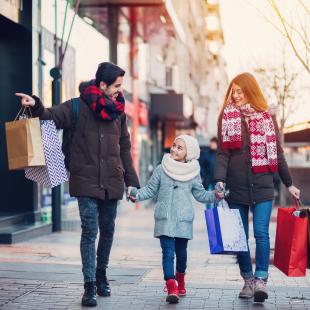 A couple and child shopping in winter