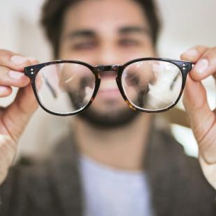 Man looking at eyeglasses