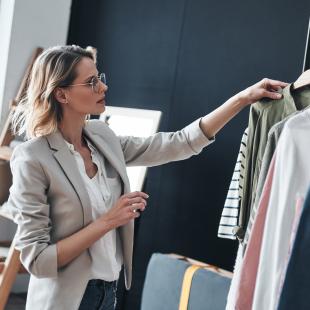 Woman looks at rack of clothing