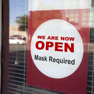 Sign on store indicating face mask required for entry