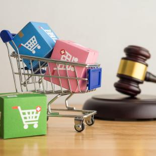 A shopping cart and gavel symbolizing retail law. 