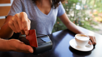 credit card swipe to pay for a coffee shop purchase