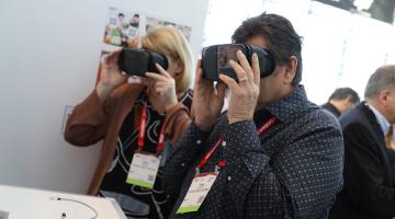 a woman and man look through virtual reality devices in the innovation lab at the big show