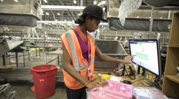 Employee at Williams Sonoma warehouse working on computer