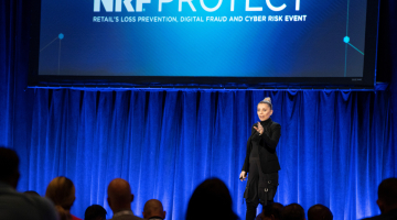 Evy Poumpouras on stage at PROTECT 2022