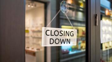 A closing down sign displayed in a window. 
