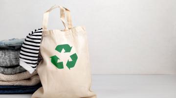 Reusable tote filled with garments. 
