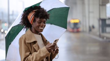 Woman on her phone in the rain. 