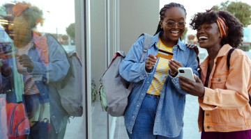 Women shopping with their phones.