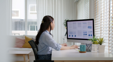 Woman working at a desktop computer.