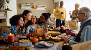 A family enjoying Thanksgiving with a turkey.