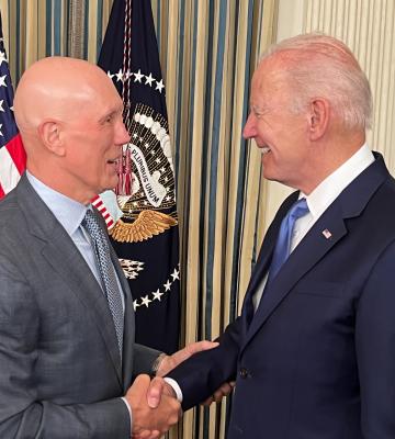 Matt Shay shakes hands with President Joe Biden at a White House bill signin
