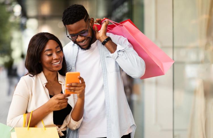 Individuals using a phone to shop.
